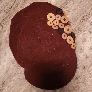 Hat with decorative buttons
